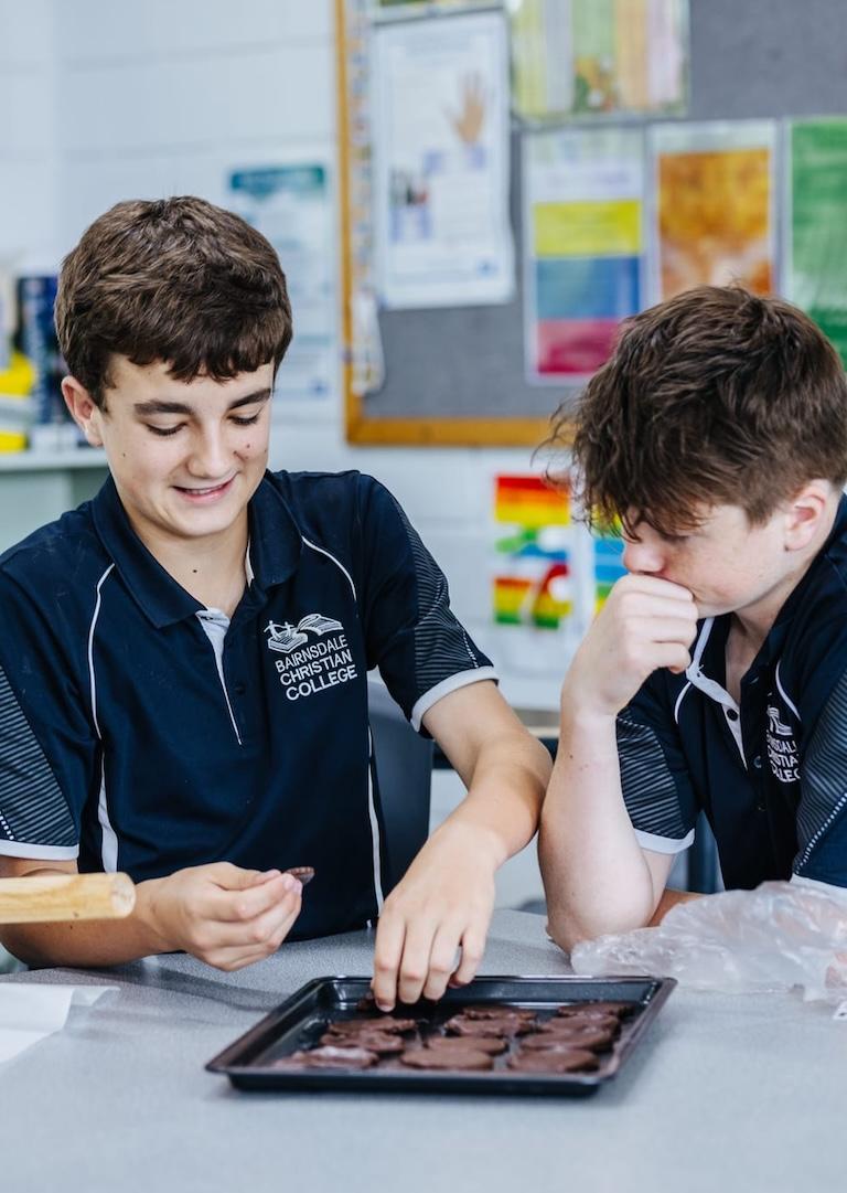 A student at Bairnsdale Christian College smiling during a classroom activity, highlighting the welcoming community.