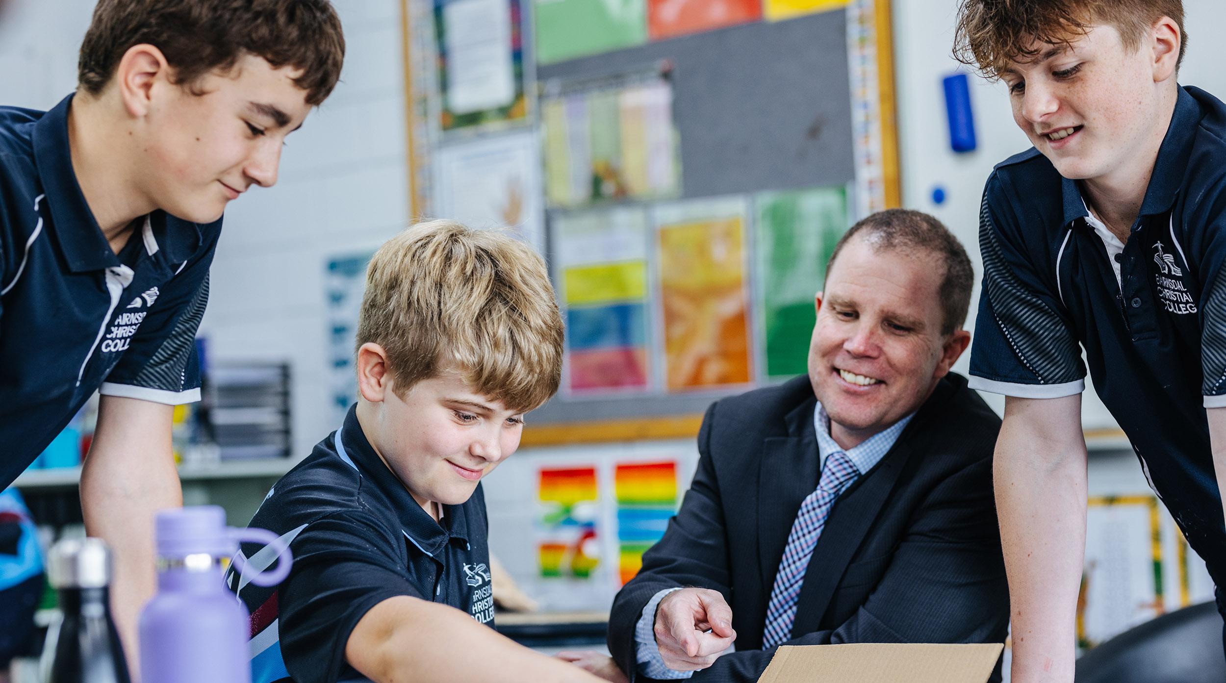 Bairnsdale Christian College's Principal Craig Dredge working with secondary students in the classroom