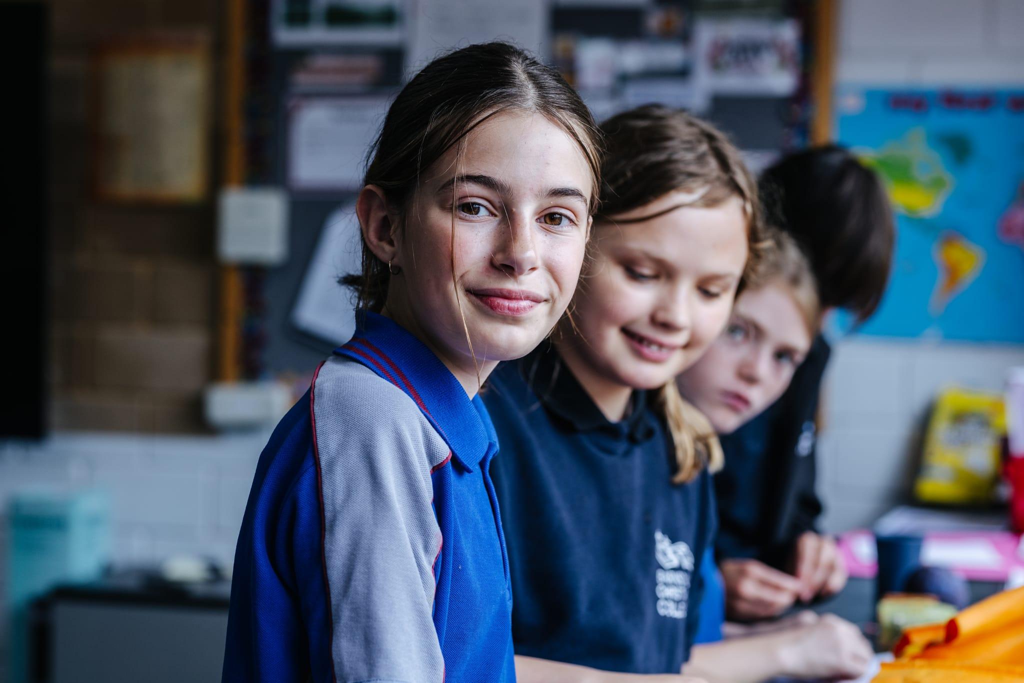 Primary school girls in sitting in gymnastics sports class