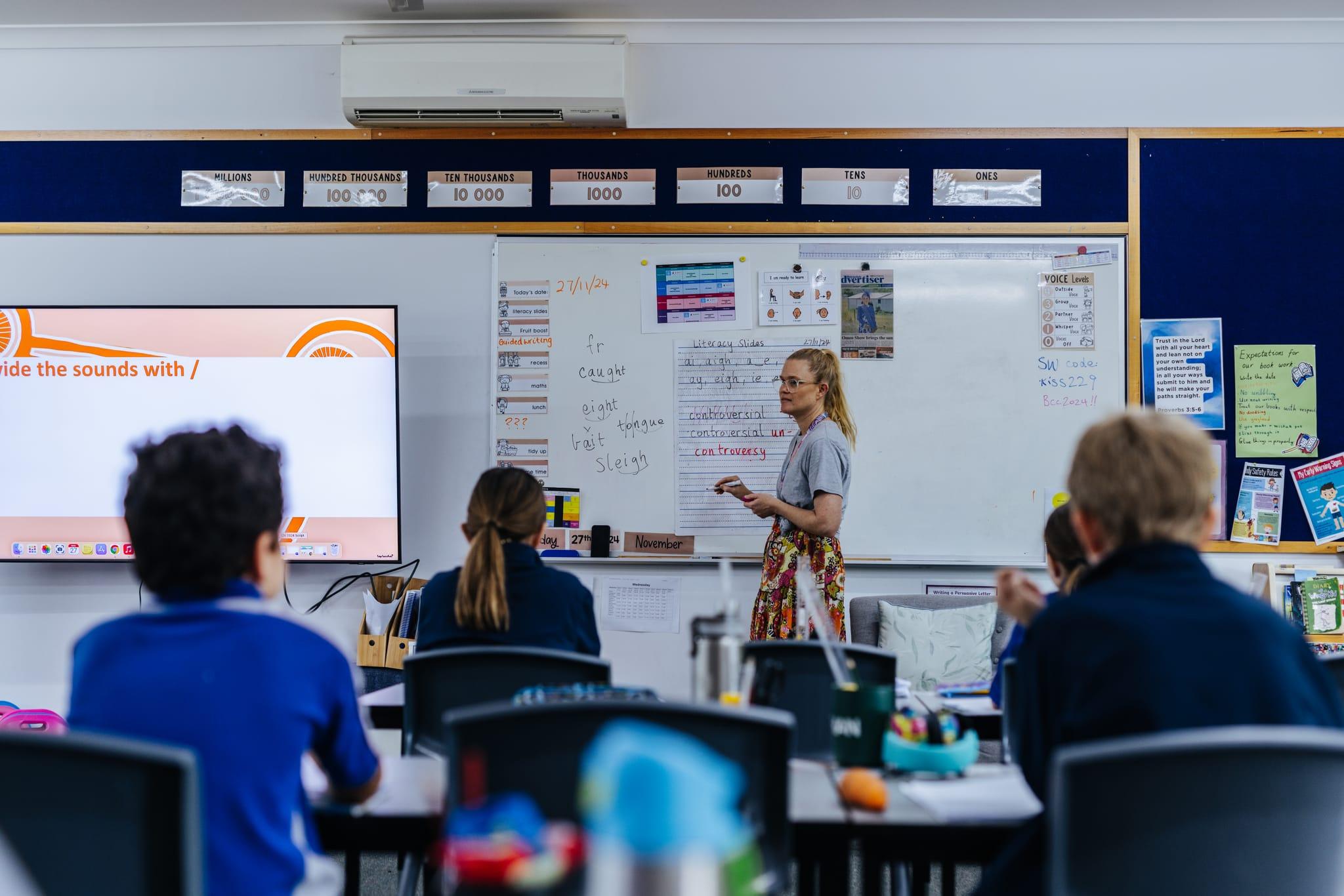 Three secondary school students collaborating on a LEGO STEM project in the classroom.